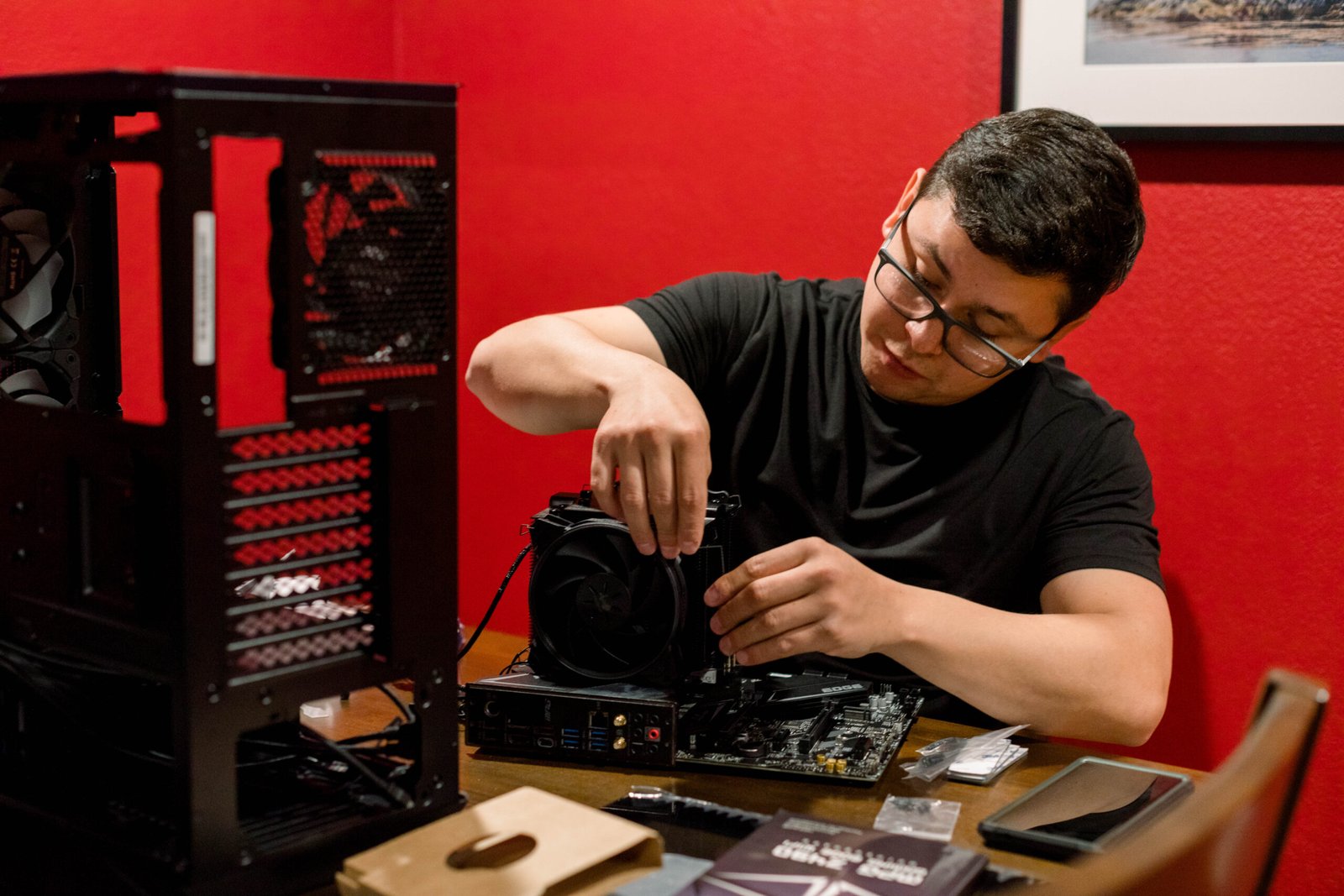 man-building-a-pc-computer-on-a-red-room-2023-11-27-05-01-25-utc-scaled-1