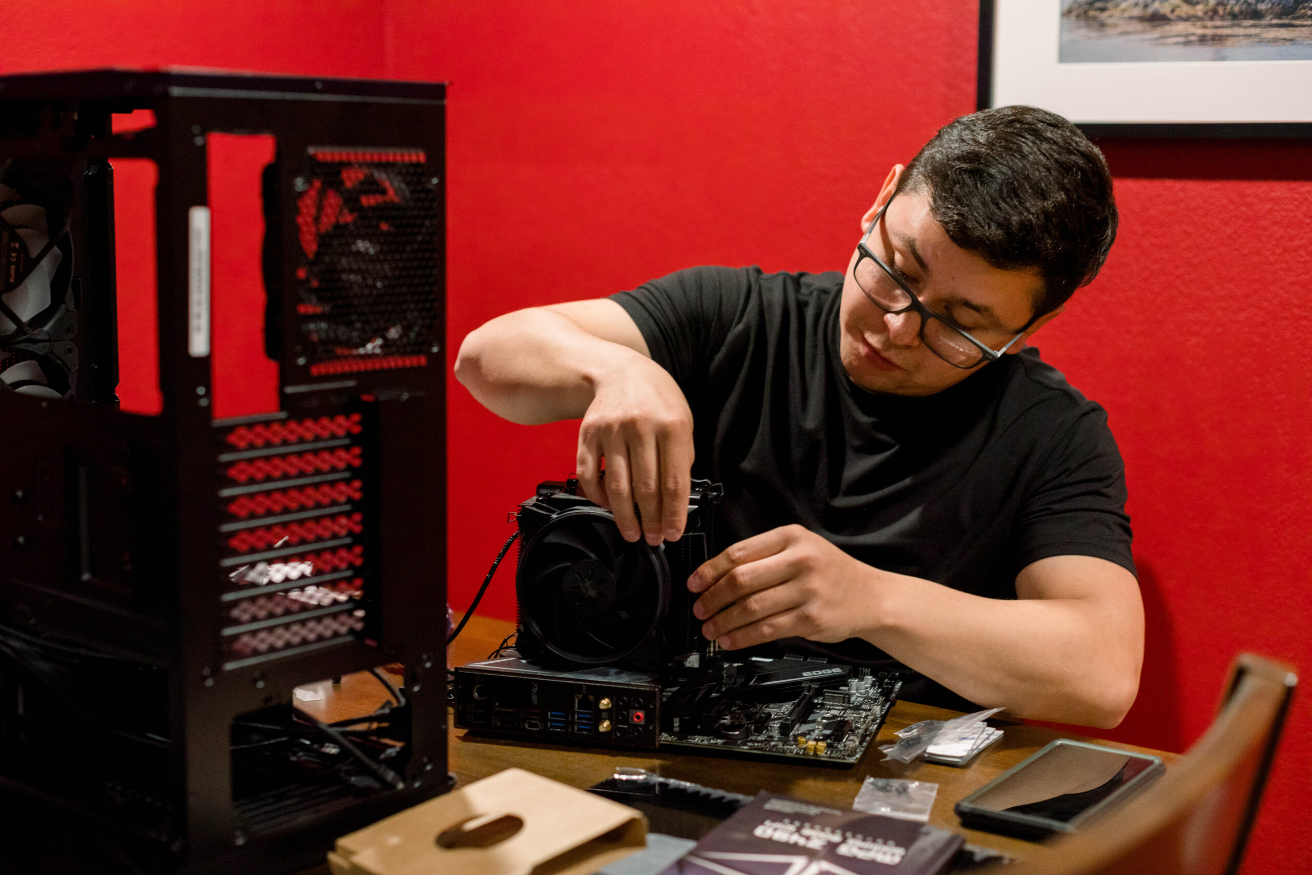 man-building-a-pc-computer-on-a-red-room-2023-11-27-05-01-25-utc