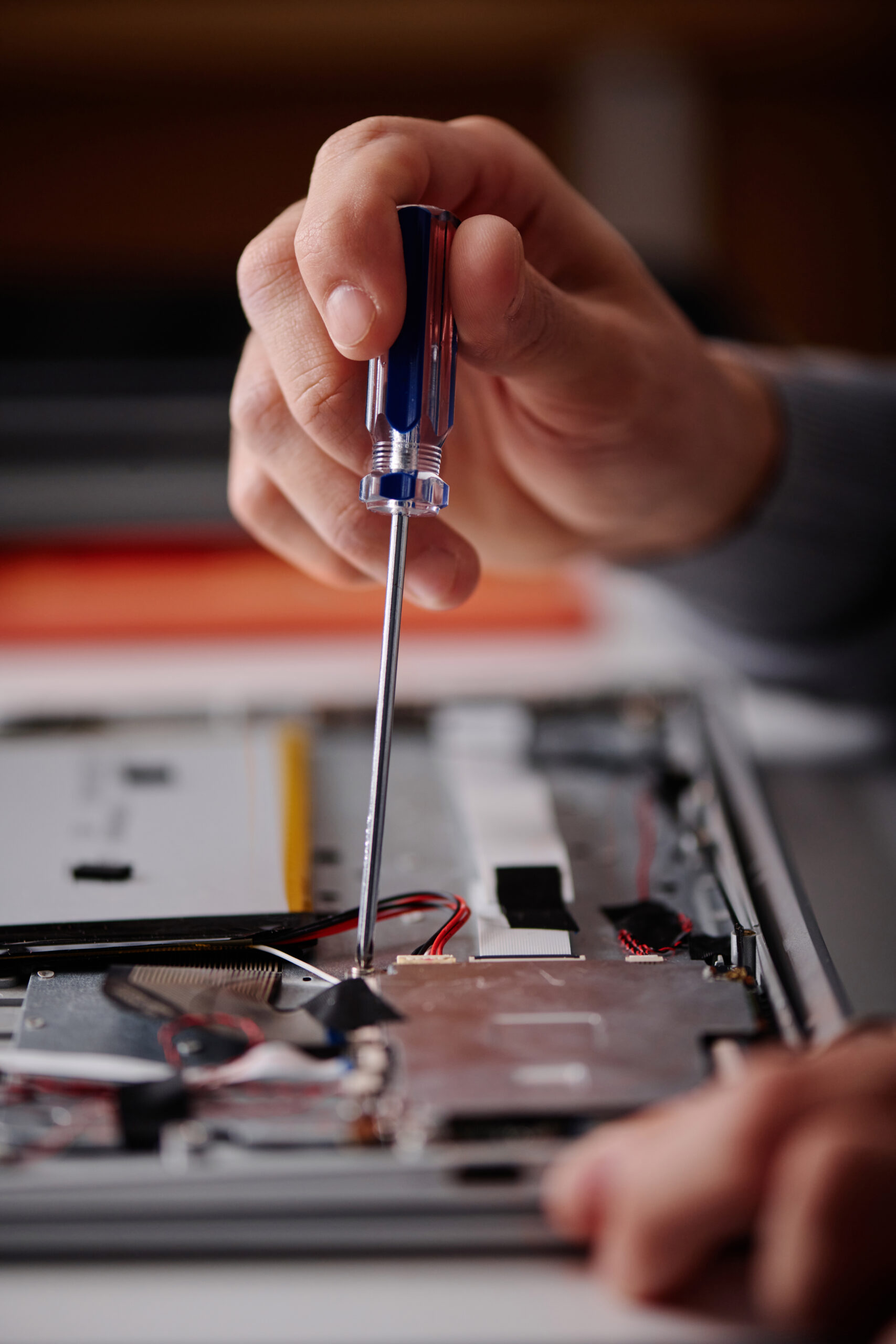 Technician Using Screwdriver for Broken Computer Repair